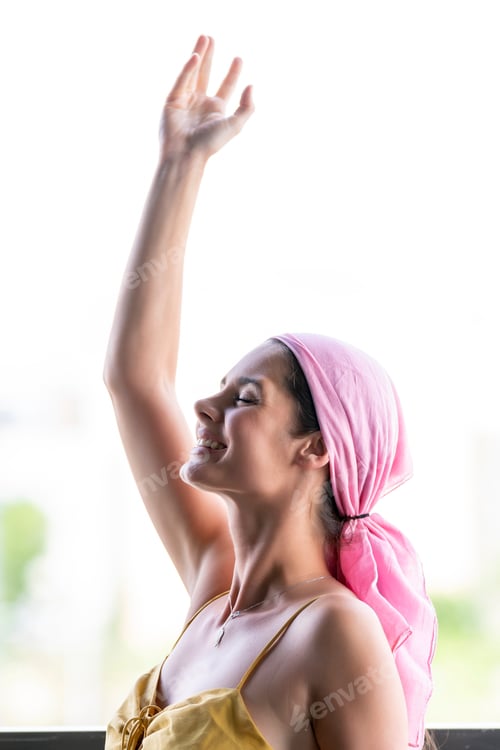 Preview: Beautiful woman claiming cancer with a pink veil on her head