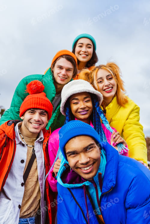 Preview: Multiracial group of young friends meeting outdoors in winter