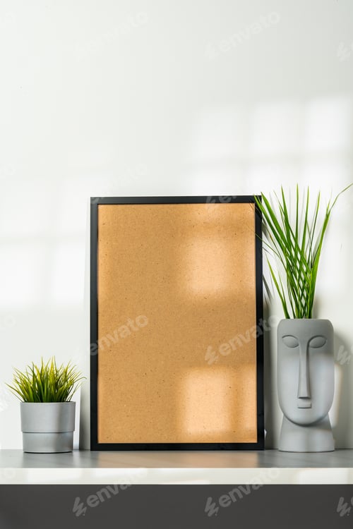 Preview: Black wooden frame and gray vase with plant leaves against white wall