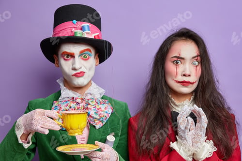 Preview: Photo of serious scary woman with painted bloody scars on face steepls fingers with intention to do