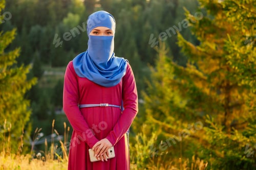 Preview: Portrait of beautiful Muslim woman with green eyes wearing blue scarf