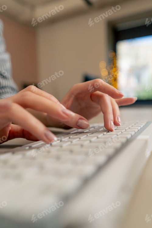 Preview: close-up of female young hands typing on white keyboard office device nude manicure professional
