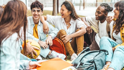 Preview: University students talking and laughing together in college campus