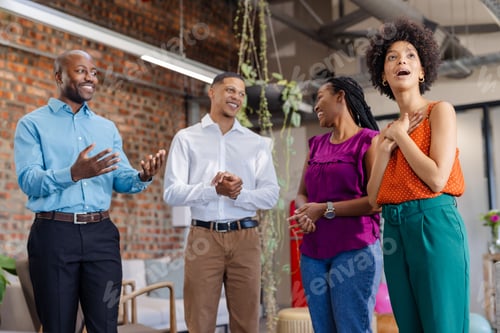 Preview: Discussing project in office, African American colleagues smiling and engaged in conversation
