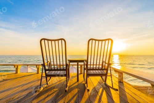 Preview: Empty wood chair and table at outdoor patio with beautiful tropi