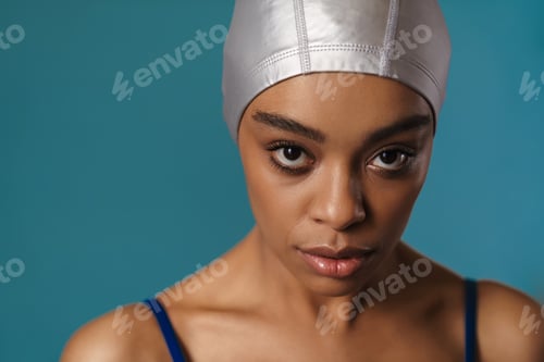 Preview: Young black swimmer posing and looking at camera