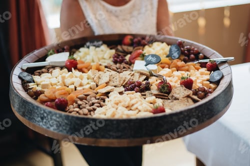 Preview: A beautiful round charcuterie board with cheese, nuts and a variety of dried and fresh fruits