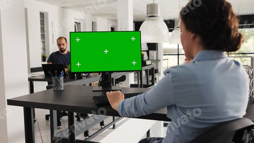 Preview: Employee at desk with greenscreen