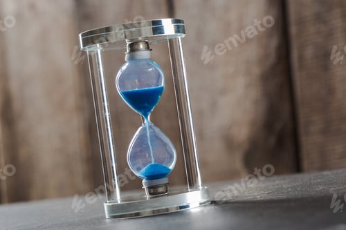 Preview: Time is passing. Blue hourglass close up