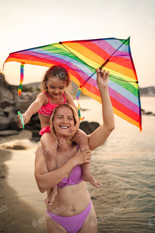 Preview: Joyful family moments at the beach during sunset with colorful kite
