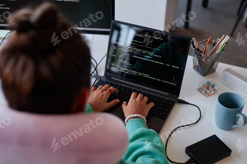Preview: Woman typing codes on laptop