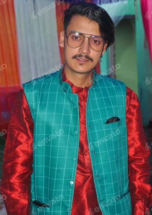 Preview: Portrait of a handsome Indian young guy with wearing kurta, pajama, nehru coat and sunglasses