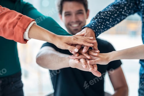 Preview: Successful smart business team celebrating good job while holding up their right hands