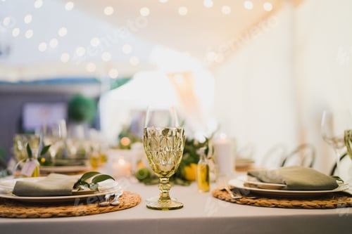 Preview: Table setting at the wedding reception. Floral compositions with beautiful flowers and greenery, can