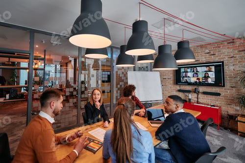 Preview: A diverse team of business professionals engage in discussions on various projects and develop new