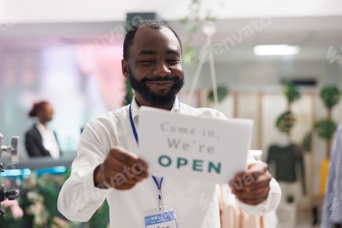 Preview: Clothes store smiling cheerful assistant hanging opening sign