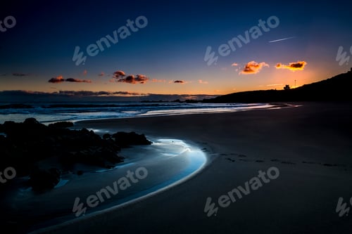 Preview: Quiet and relaxed scenic beach place during dusk sunset with coloured sky in background