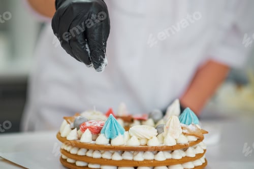 Preview: Chef decorating with a pastry bag with cream