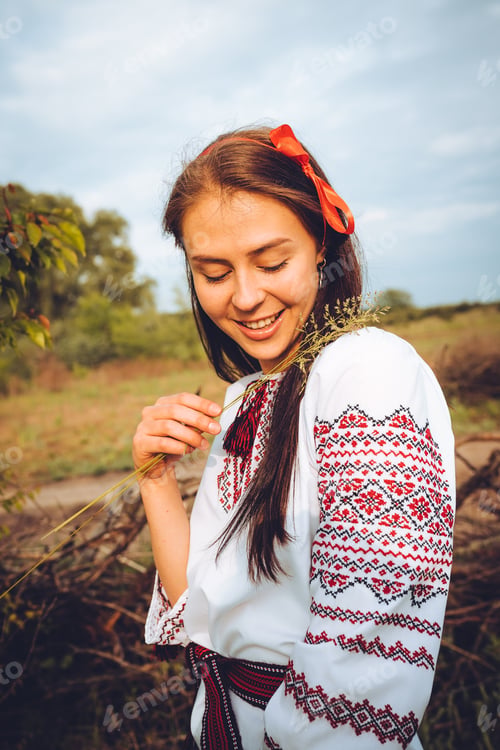 Preview: Photo of a smiling young woman in ethnic ukrainian shirt
