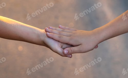 Preview: Children walk hand in hand. Selective focus.