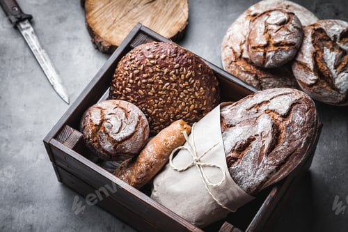 Preview: A basket full of delicious fresh bread on wooden background