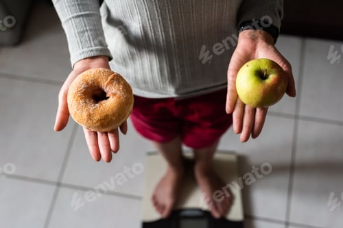 Preview: Woman Hold An Apple And Donuts And Stand On Scale At Home, Concept Of Healthy