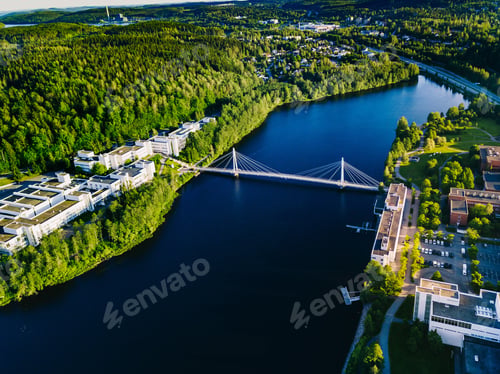 Preview: Aerial view of blue lake with cable-stayed bridge and green summer town in Finland.