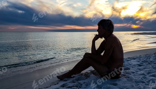 Preview: Silhouetted baby boomer sitting on beach thinking about his future in psychological moment.