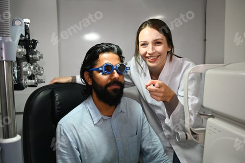 Preview: Image of happy male patient undergoing vision check with special ophthalmic glasses.