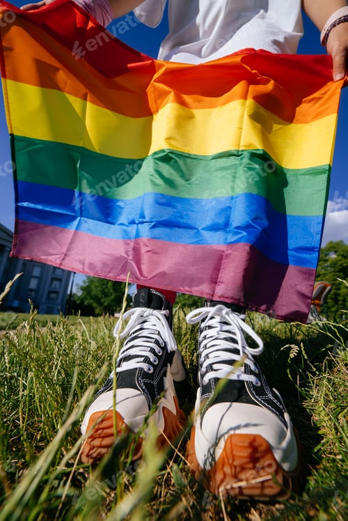 Preview: Cropped photo of young woman with LGBT pride flag.