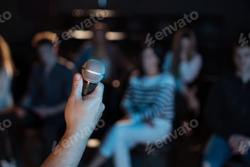 Preview: Obscured presenter holding microphone , presentation at conference concept