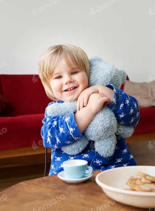 Preview: A boy toddler cuddling his teddy bear