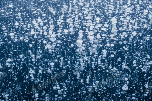Preview: Baikal ice patterns. Frozen Lake Baikal with bubbles and cracks. Blue textured ice background.