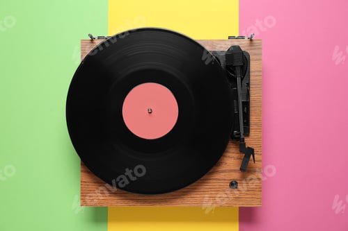 Preview: Modern turntable with vinyl record on color background, top view