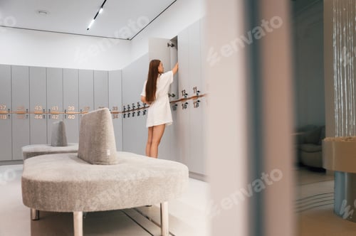 Preview: Woman is in the gym changing room with lockers