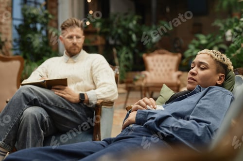 Preview: Woman lying on couch during therapy session