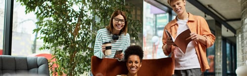Preview: Colleagues enjoying a relaxing moment in a vibrant hotel lounge during their business trip