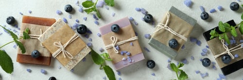 Preview: Different natural soap for skin care on white textured table