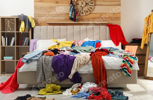 Preview: Pile of clothes on bed in messy room. Fast fashion concept