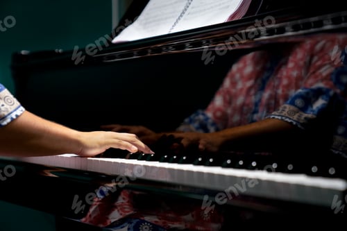 Preview: Isolated hands playing on the piano, dark background