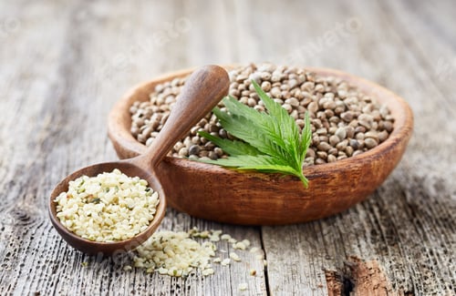 Preview: Organic hulled hemp seeds with plant on wooden old board