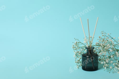 Preview: Aroma scent diffuser and flowers on blue background