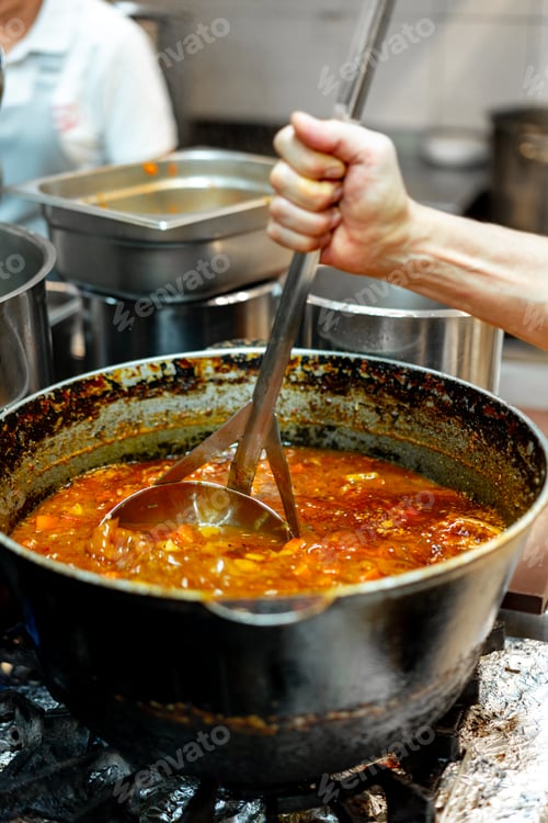 Preview: Chef cooking food at restaurant kitchen close up