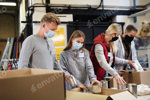 Preview: Group of volunteers in community charity donation center, food bank and coronavirus concept.