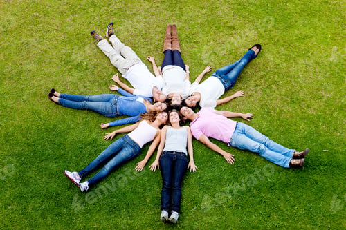 Preview: Group Of Friends Lying Outdoors Making A Circle - Fullbody