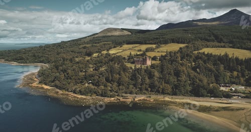 Preview: Scotland's Arran island landscape aerial zooming view: forests, meadows, mountains at summer day