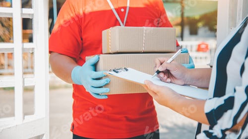 Preview: consumer is signing a document to receive a parcel from a home courier.