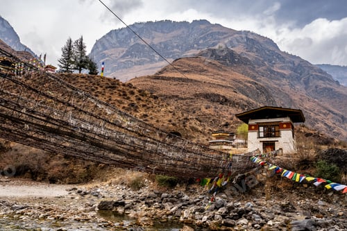 Preview: Traditional Bhutanese house with suspension bridge and prayer flags