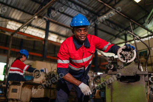 Preview: Male technician worker working and repair pressing metal machine at factory.