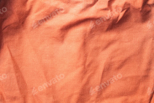 Preview: Texture of old crumpled textile material in peach fuzz color